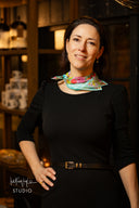 Woman wearing a colorful scarf in a dimly lit room