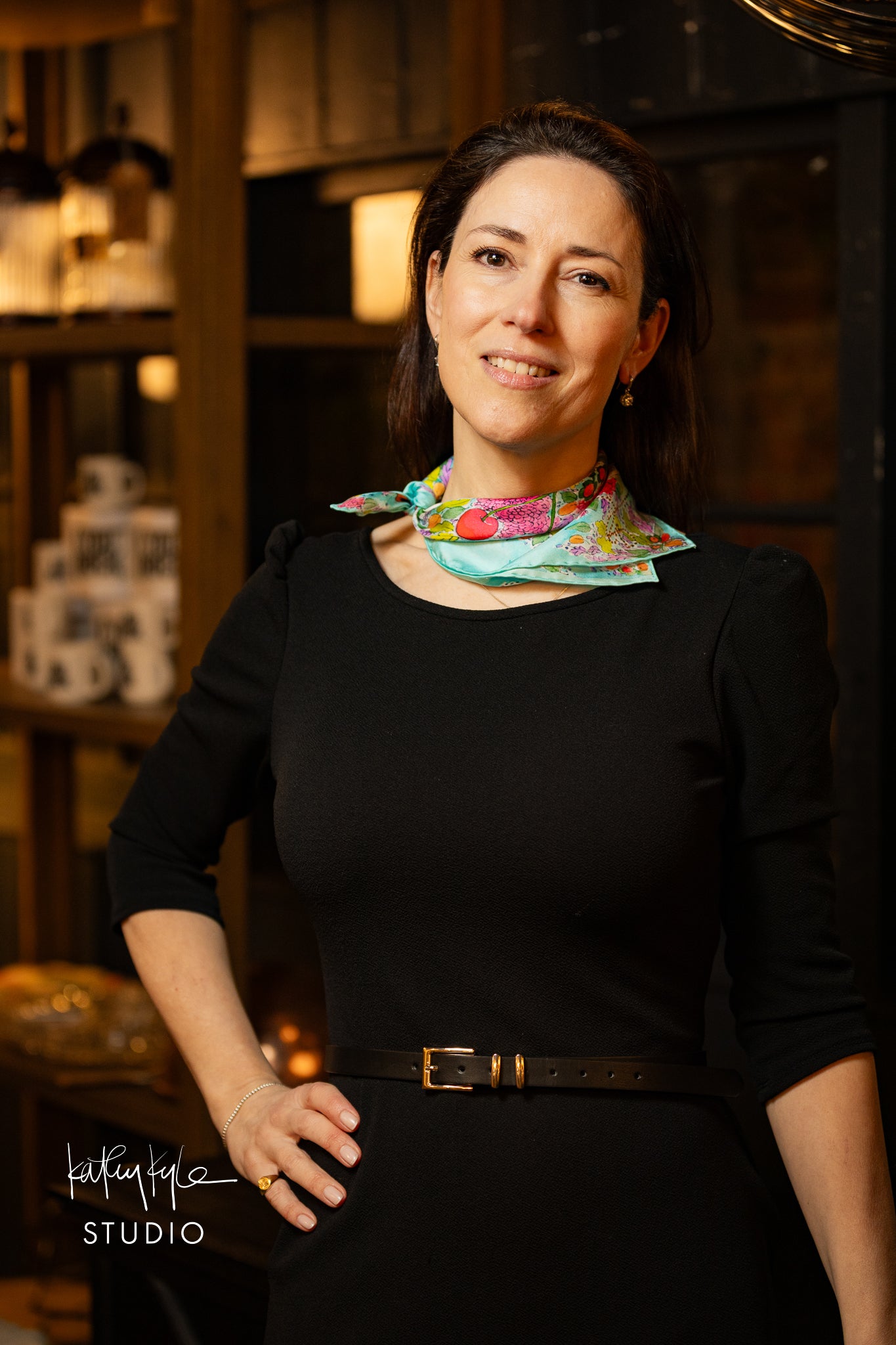 Woman wearing a colorful scarf in a dimly lit room