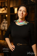 Woman wearing a colorful scarf in a dimly lit room